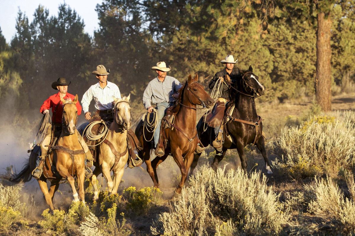 Four cowboys ride together, in a file photo. (Jeanne Provost/Shutterstock)