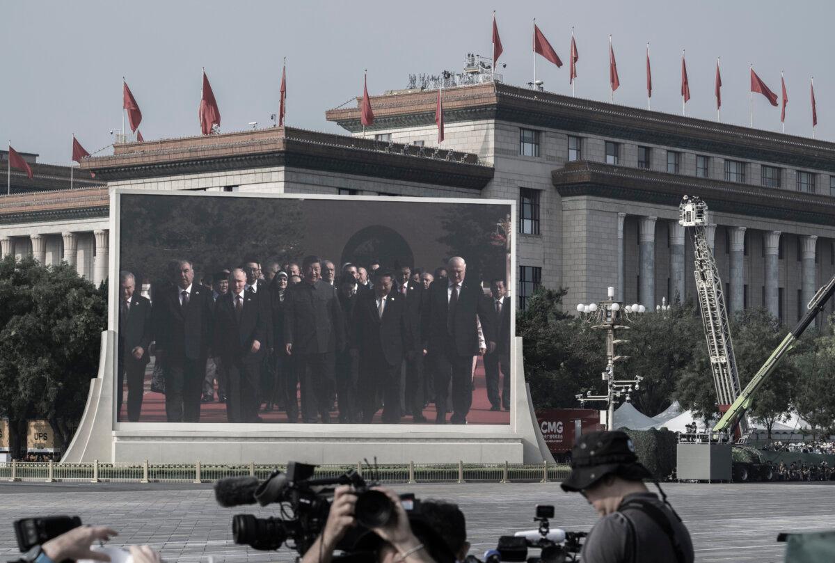 Chinese leader Xi Jinping (C), Russian President Vladimir Putin, and North Korean leader Kim Jung Un, and others on a large screen as they arrive at a military parade marking the 80th anniversary of victory over Japan and the end of World War II, in Tiananmen Square in Beijing on Sept. 3, 2025. (Kevin Frayer/Getty Images)