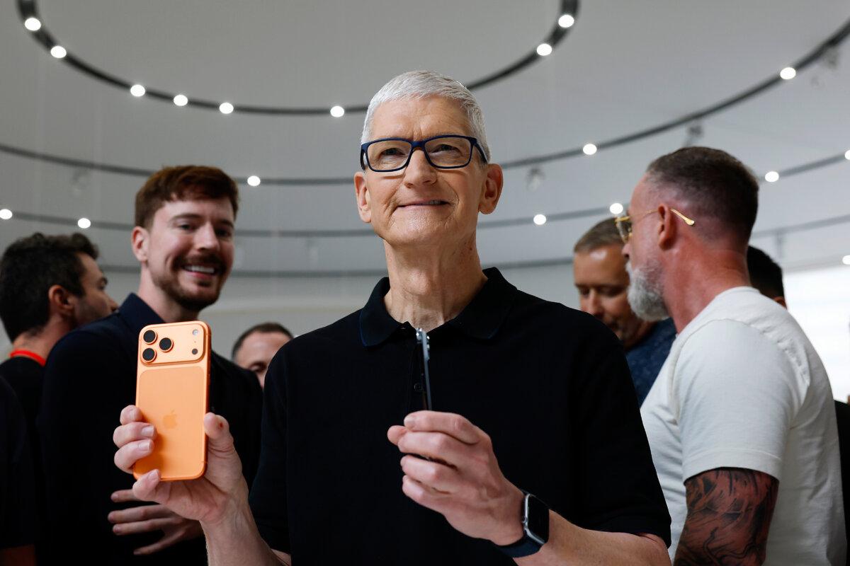Apple CEO Tim Cook holds an iPhone at Apple headquarters in Cupertino, Calif., on Sept. 9, 2025. (Justin Sullivan/Getty Images)