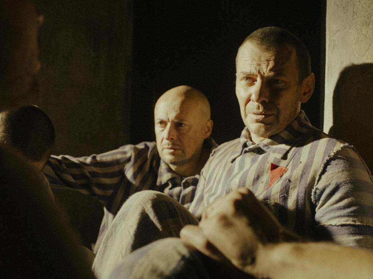 Franciszek Gajowniczek (Bartosz Bulawa, L) and Father Maximilian Kolbe (Marcin Kwasny) suffer in a cell in Auschwitz, in “Triumph of the Heart.” (Sherwood Fellows)