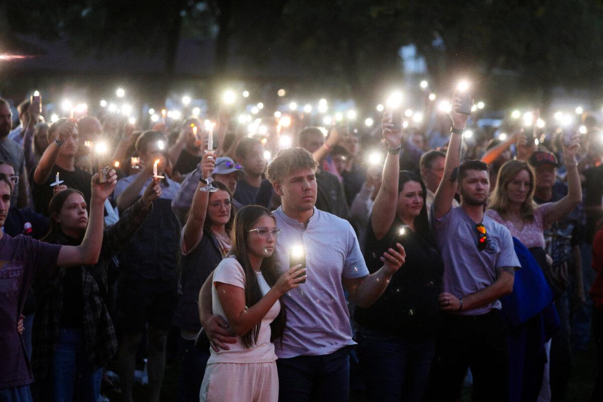 People attend a vigil at Orem City Center Park, after U.S. right-wing activist and commentator, Charlie Kirk was fatally shot during an event at Utah Valley University, in Orem, Utah, on Sept. 11, 2025. (Reuters/Jim Urquhart)