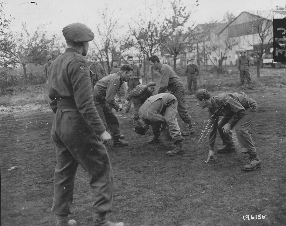 Late in the war in November 1944, Americans in Holland teach U.S. football to British Allies. (Public Domain)