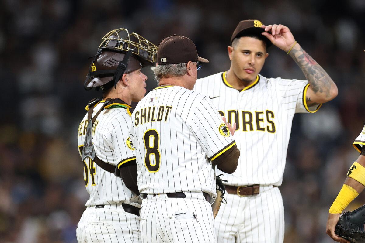 Manager Mike Shildt (C), Manny Machado (13), and Freddy Fermin (54) look on during a pitching change for Jeremiah Estrada (56) of the San Diego Padres during the seventh inning of a game against the Cincinnati Reds at Petco Park in San Diego on Sept. 8, 2025. (Sean M. Haffey/Getty Images)