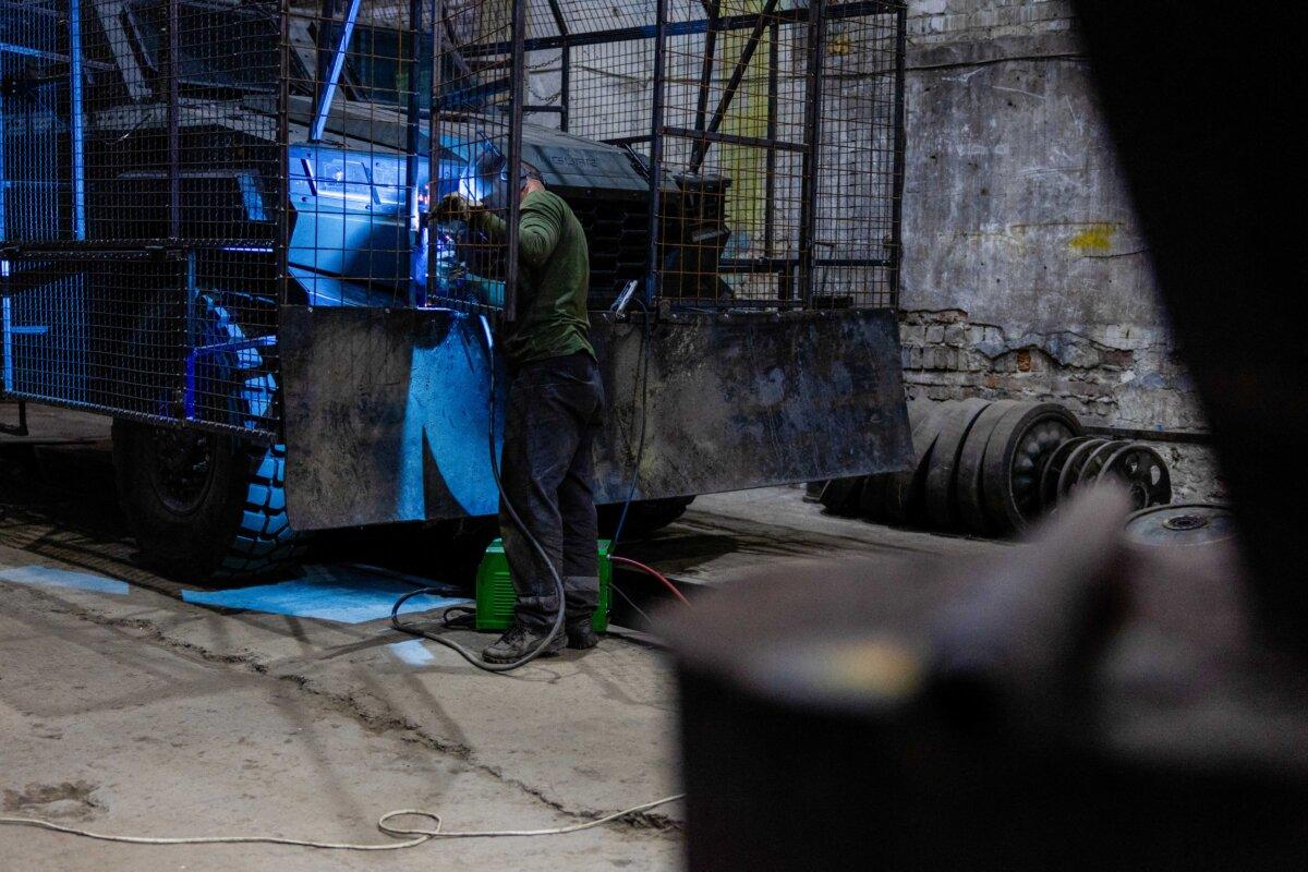 A Ukrainian soldier in Donetsk makes protective cages for military equipment to counter Russian drones on Sept. 16, 2025. (Tetiana Dzhafarova/AFP via Getty Images)