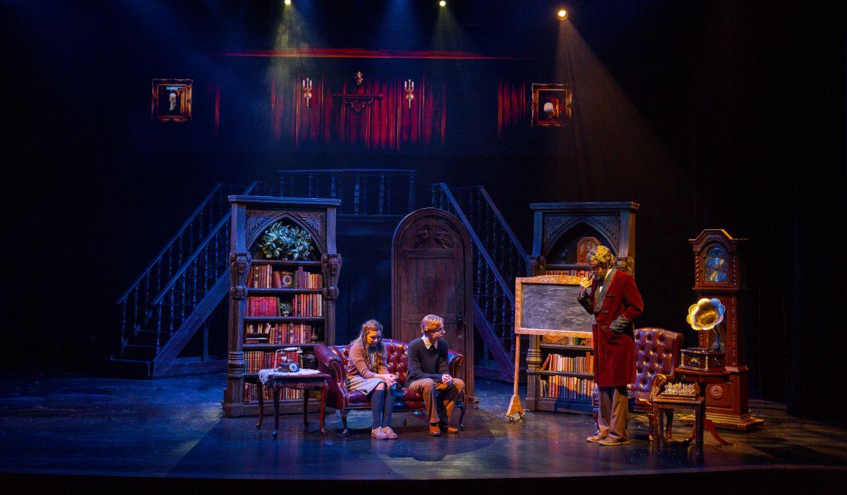 The Professor (R, Noah Stratton) tries to reason with Susan (Bethany Bliss) and Peter (Brinton Stratton), in "The Lion, the Witch, and the Wardrobe." (The Academy of Arts Logos Theatre)