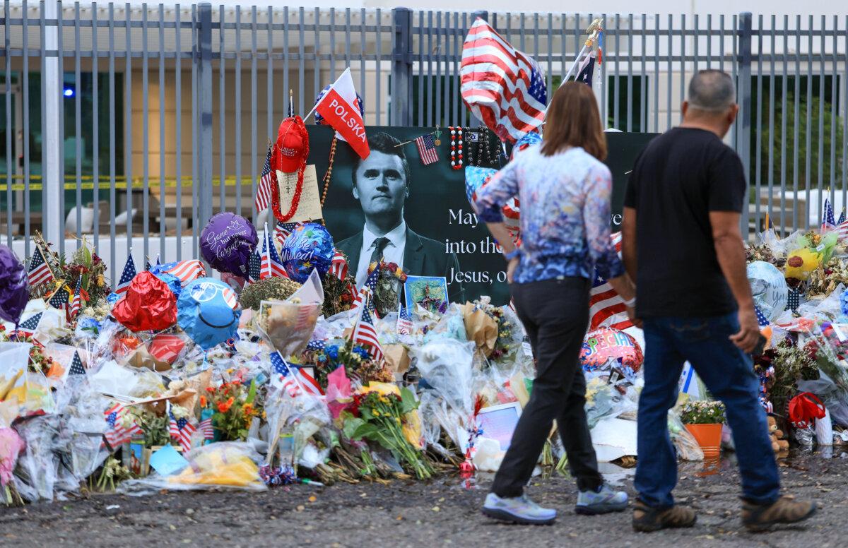 People visit the makeshift memorial for Charlie Kirk outside the headquarters of Turning Point USA in Phoenix on Sept. 18, 2025. (Joe Raedle/Getty Images)