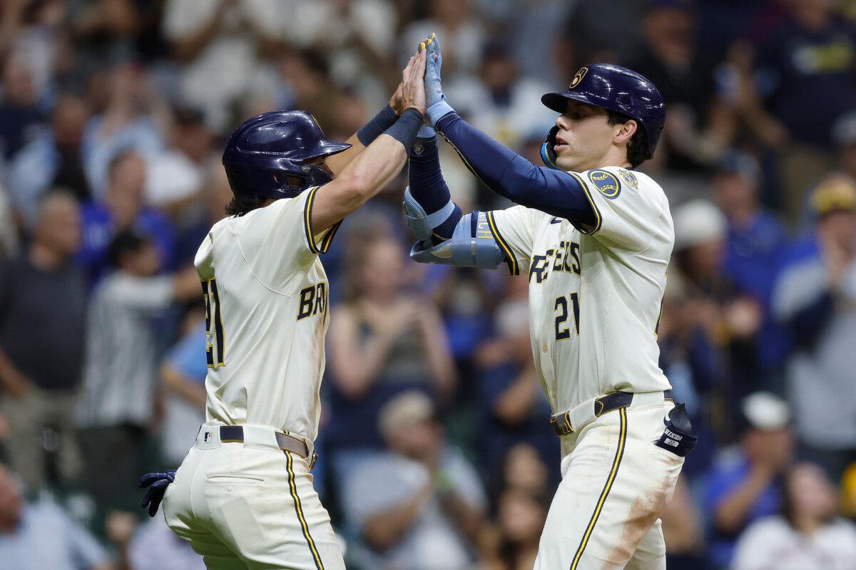 Christian Yelich (R) of the Milwaukee Brewers is congratulated by teammate Sal Frelick after hitting a two-run homer against the Los Angeles Angels at American Family Field in Milwaukee on Sept. 16, 2025. (John Fisher/Getty Images)
