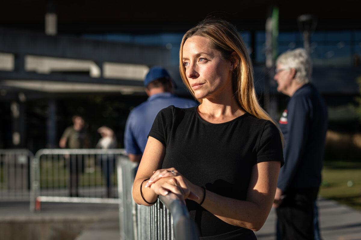 Megan Beckham Strader, who witnessed the assassination of Charlie Kirk on Sept. 10, 2025, returns to the shooting scene to pay tribute to Kirk at Utah Valley University in Orem, Utah, on Sept. 16, 2025. (Madalina Kilroy/The Epoch Times)