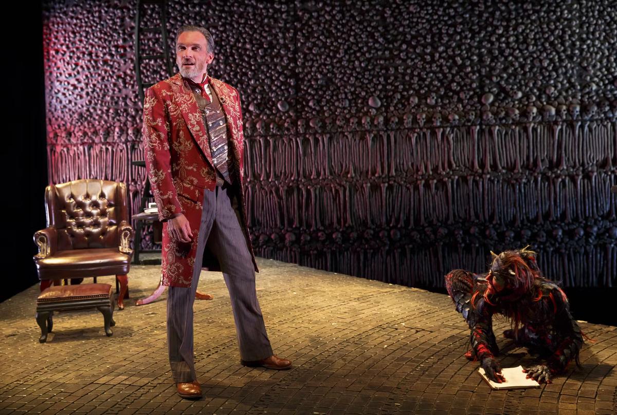 Screwtape (Brent Harris) plots with Toadpipe (Shiloh Goodin), in "The Screwtape Letters." (Joan Marcus)