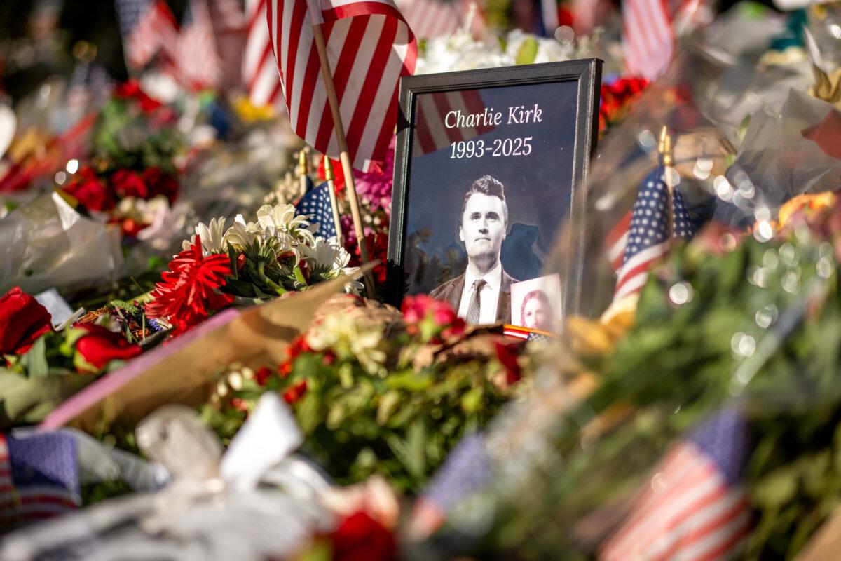 Flowers, American flags, and other items mourning Charlie Kirk at Utah Valley University in Orem, Utah, on Sept. 16, 2025. (Madalina Kilroy/The Epoch Times)