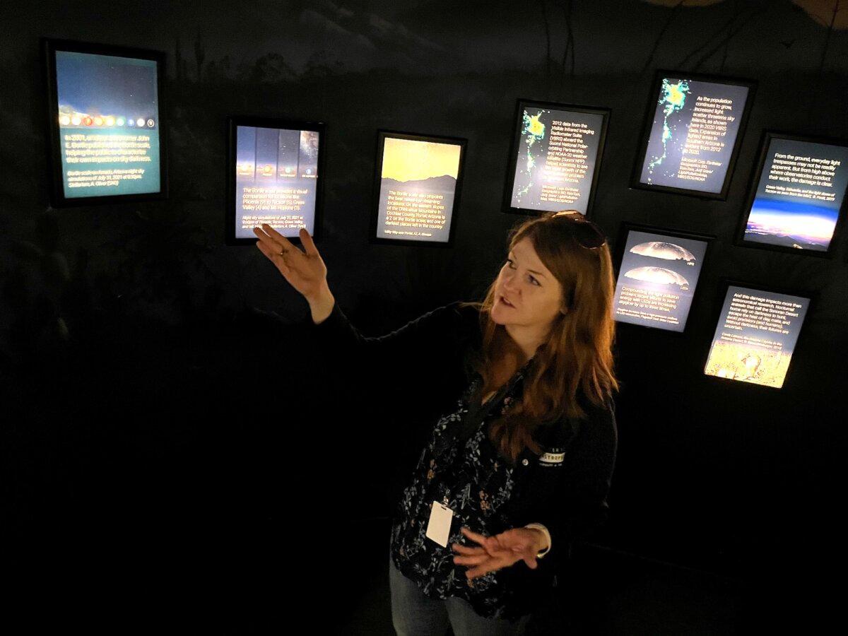 Amy Oliver, public information officer at the Fred Lawrence Whipple Observatory, discusses a display on Aug. 22, 2025. (Allan Stein/The Epoch Times)