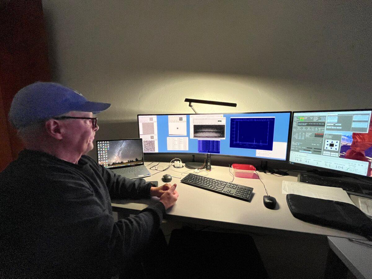 Telescope operator Mike Calkins looks at data indicating a possible black hole from the Whipple Observatory in Amado, Ariz., on Aug. 22, 2025. (Allan Stein/The Epoch Times)