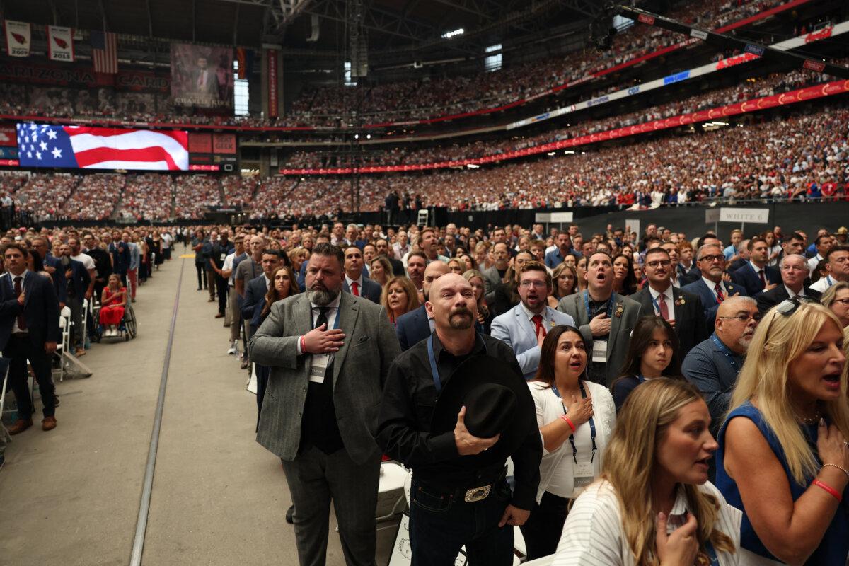 Attendees pray during the public memorial service for conservative commentator Charlie Kirk at State Farm Stadium in Glendale, Ariz., on Sept. 21, 2025. (Patrick T. Fallon/AFP via Getty Images)