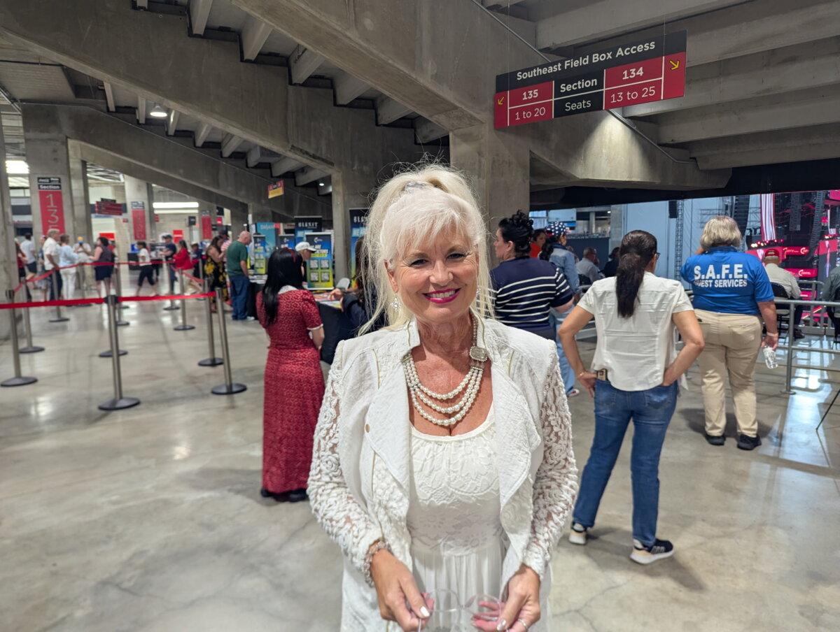 An attendee of Charlie Kirk’s memorial service who asked to be identified only by her first name, Joy, stands inside State Farm Stadium in Glendale, Ariz., on Sept. 21, 2025. (Ryan Morgan/The Epoch Times)