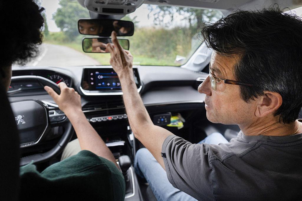 A driving instructor gives instructions to a person during a driving lesson in Quimper, western France, on July 24, 2025. (Fred Tanneau/AFP via Getty Images)