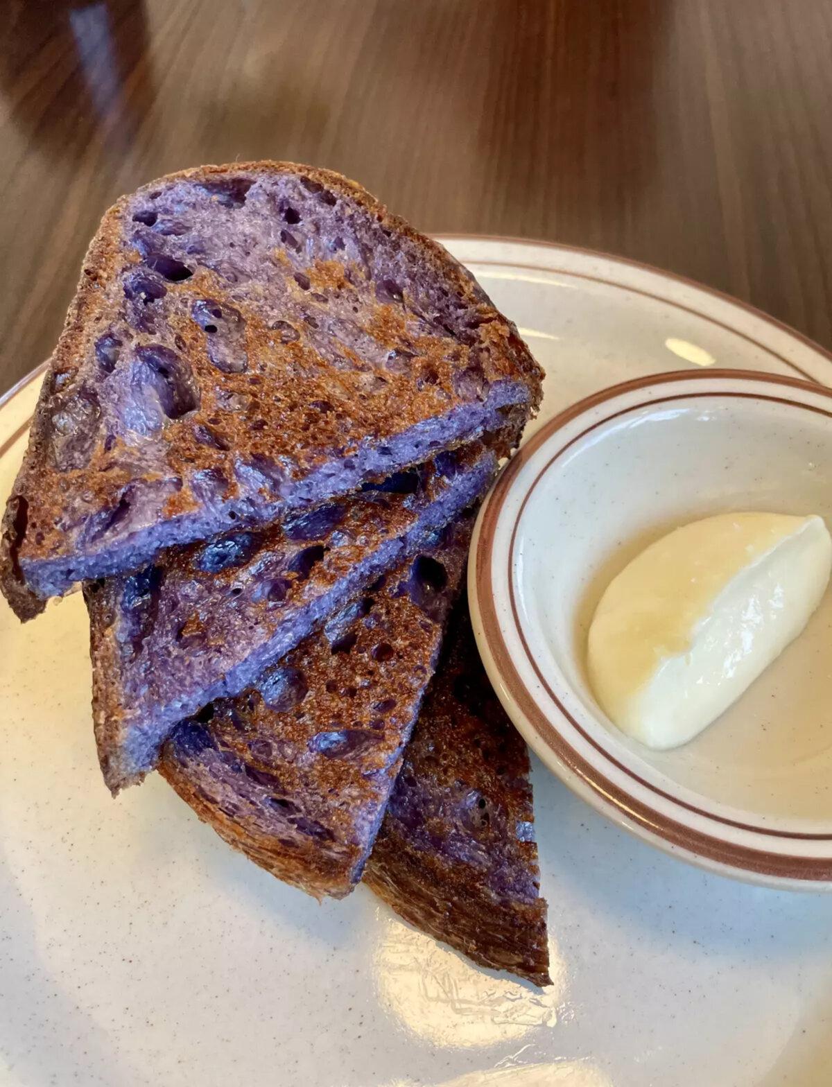 The blue corn masa sourdough bread with a side of beef tallow butter at Le Hut Dinette restaurant in Santa Ana. The bread is made by 61 Hundred Bread. (Jenn Harris/The Los Angeles Times/TNS)