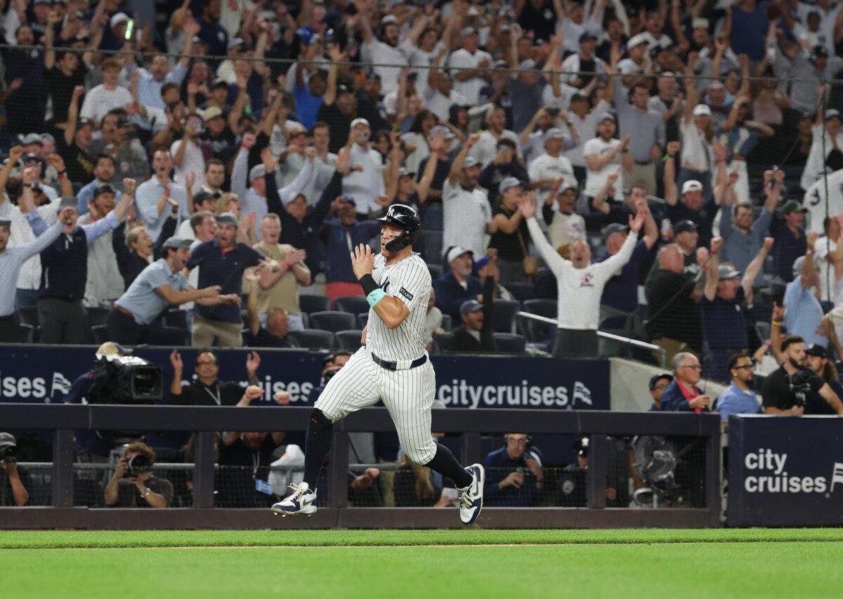 Aaron Judge of the New York Yankees scores the winning run, hitting a walk-off single in the ninth inning to win the game against the Chicago White Sox during their game at Yankee Stadium in New York City on Sept. 23, 2025. (Al Bello/Getty Images)