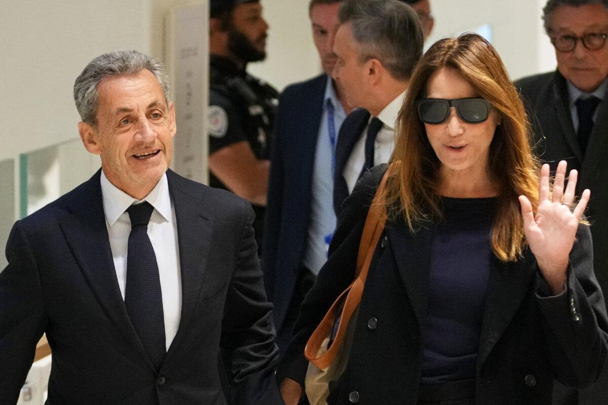 Former French President Nicolas Sarkozy (L) and his wife, Carla Bruni, arrive at the Tribunal de Paris courthouse, in Paris, France, on Sept. 25, 2025. (AP Photo/Christophe Ena)