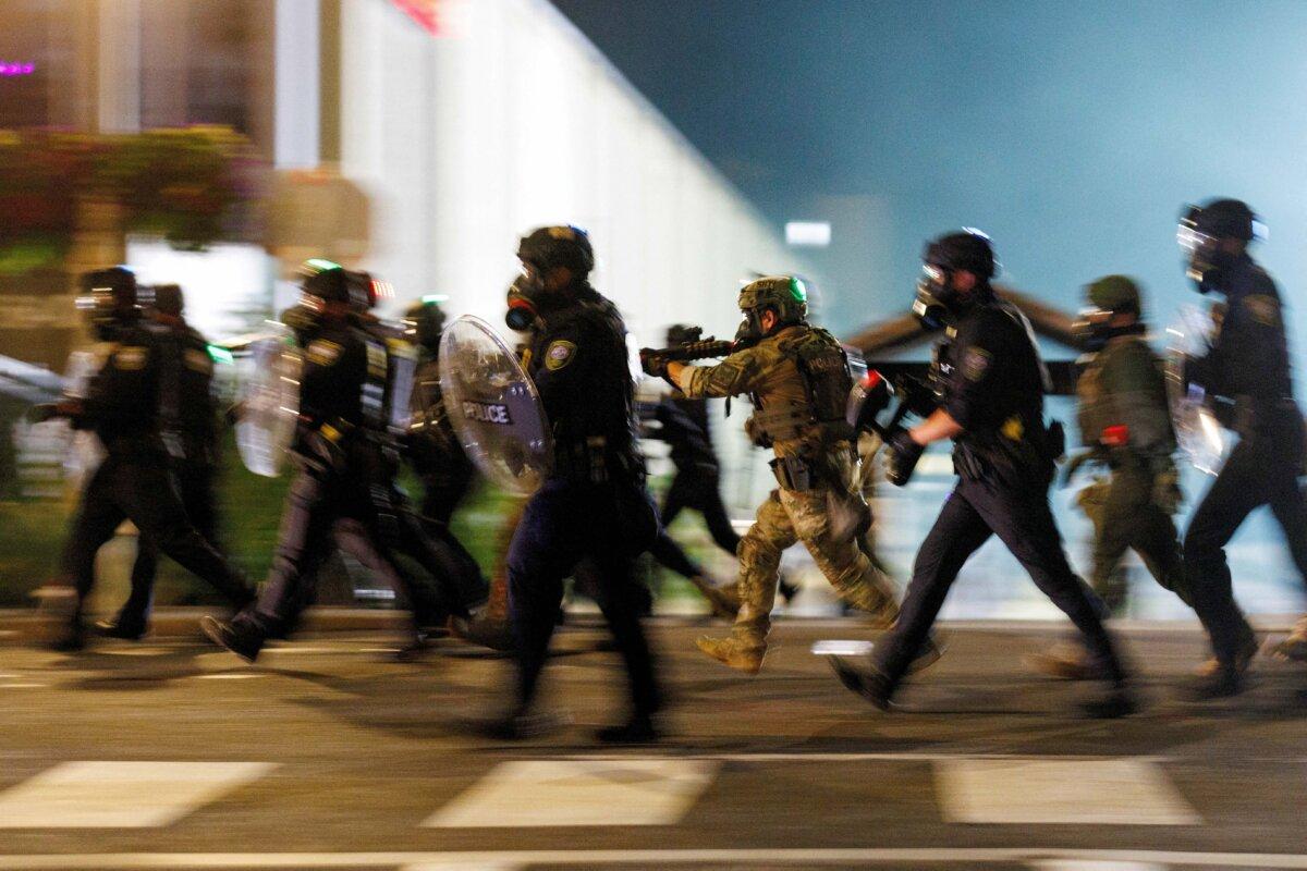 ICE agents charge towards protesters at an ICE detention facility in Portland, Ore., on Sept. 1, 2025. (John Rudoff/Reuters)
