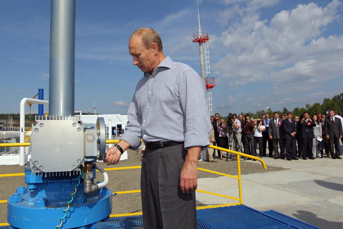 Russian Prime Minister Vladimir Putin opens a throttle during the opening ceremony for the Russian section of the Russia–China oil pipeline in the far eastern region of Amur on Aug. 29, 2010. (Alexey Druzhinin/Ria Novosti/AFP via Getty Images)