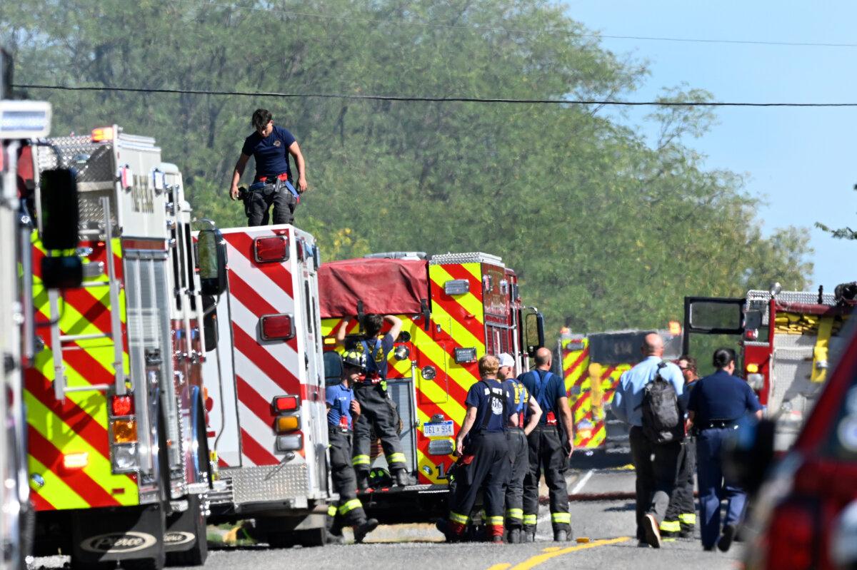 Fire department personnel stand along McCandlish Road near a shooting that took place at The Church of Jesus Christ of Latter-day Saints in Grand Blanc, Mich., on Sept. 28, 2025. (Jose Juarez/AP Photo)