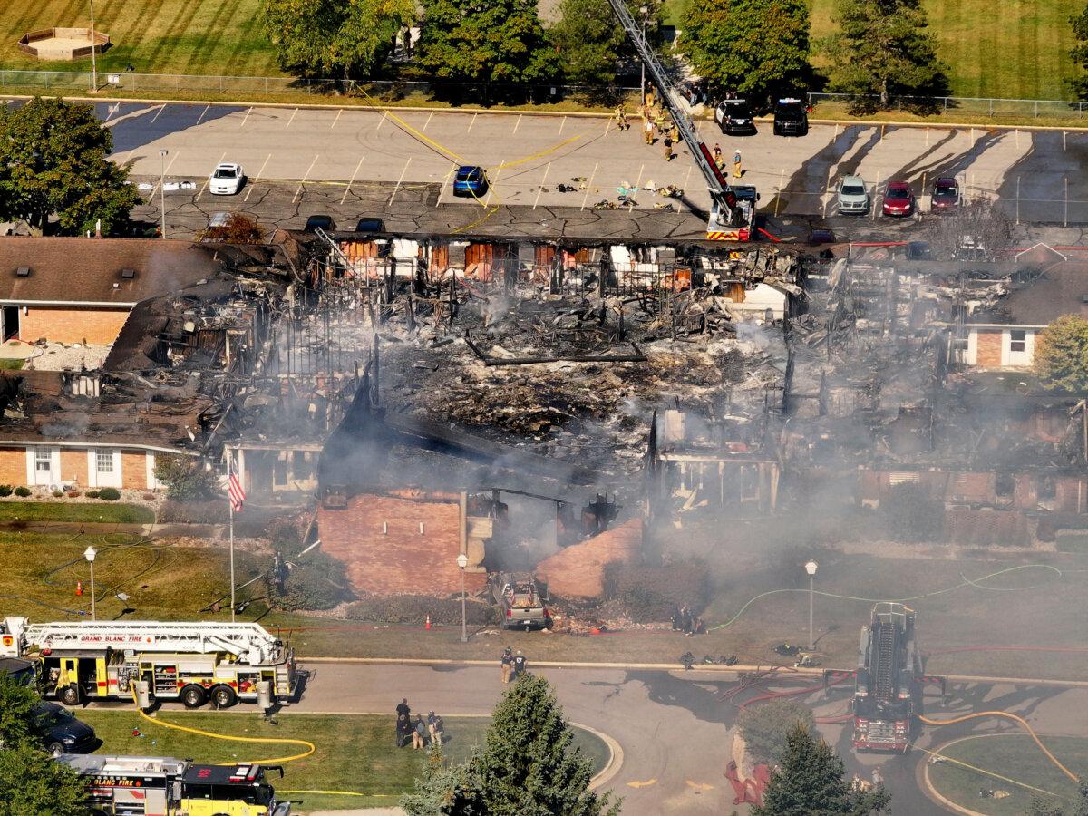 Emergency crews respond to a shooting and fire at the Church of Jesus Christ of Latter-day Saints in Grand Blanc, Mich., on Sept. 28, 2025. (David Guralnick/Detroit News via AP)