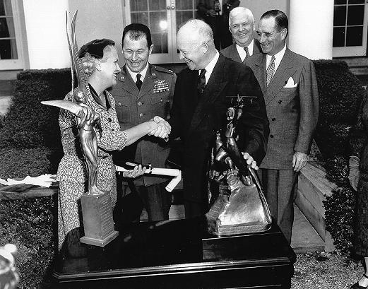 Jackie Cochran and Chuck Yeager being presented with the Harmon International Trophies by President Dwight D. Eisenhower. Air Force Flight Test Center History Office. (Public Domain)