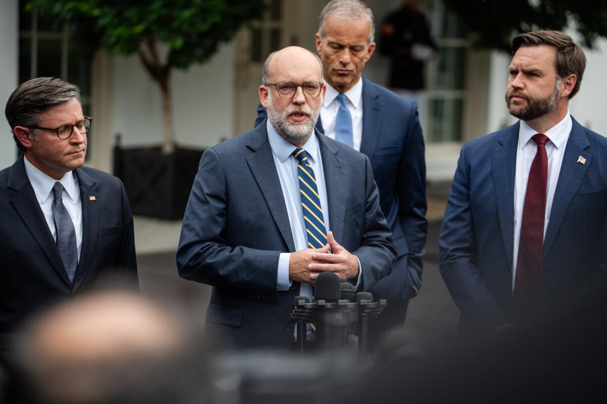Office of Management and Budget Director Russel Vought (C), joined by Vice President JD Vance (R), House Speaker Mike Johnson (L), and Senate Majority Leader John Thune (rear C), speaks at the White House on Sept. 29, 2025. (Madalina Kilroy/The Epoch Times)