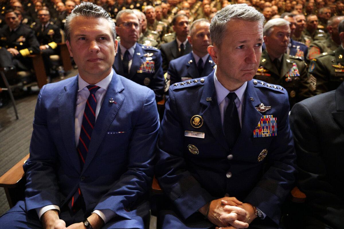 Secretary of War Pete Hegseth (L) and Chairman of the Joint Chiefs of Staff Air Force Gen. Dan Caine listen as President Donald Trump speaks to senior military members at Marine Corps Base Quantico in Quantico, Va., on Sept. 30, 2025. (Alex Wong/Getty Images)