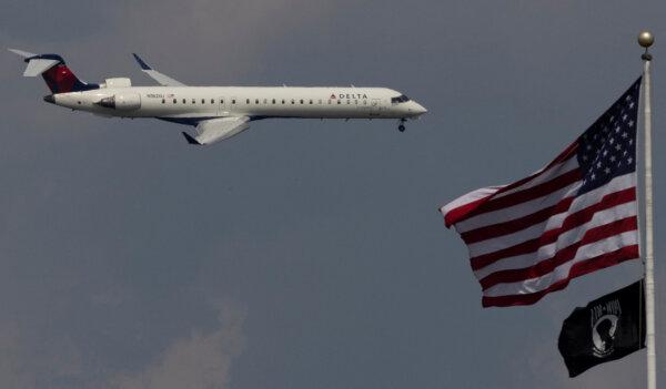 A Delta Air Lines commercial aircraft flies over Washington as it approaches Washington Dulles International Airport, as seen from Washington, on Aug. 5, 2024. (Umit Bektas/Reuters)