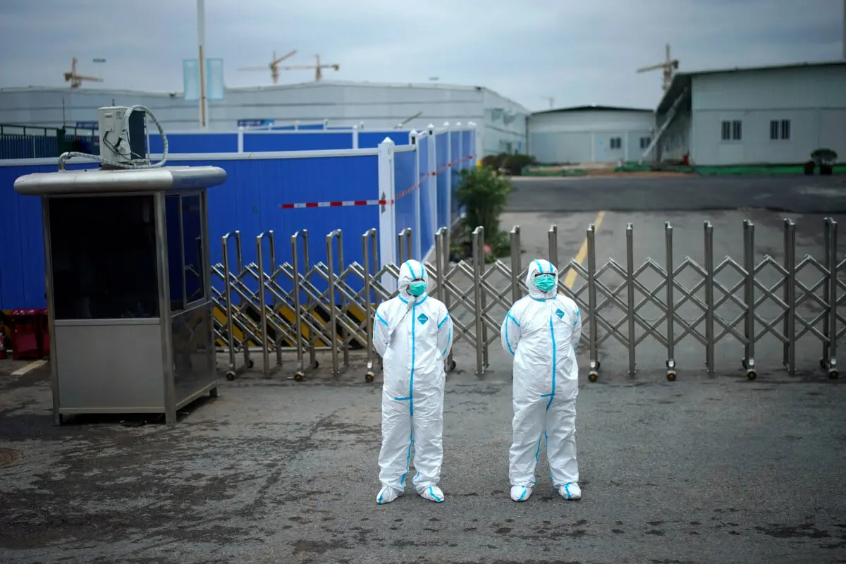 Workers in protective suits at the Leishenshan Hospital, a makeshift hospital for treating patients with COVID-19, in Wuhan, Hubei Province, China, on April 11, 2020. (Aly Song/File Photo /Reuters)