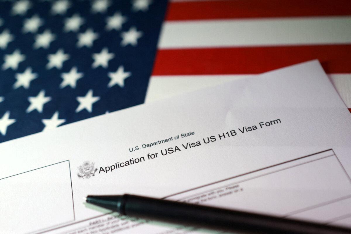 A U.S. flag and a U.S. H-1B Visa application form are seen in this illustration taken on Sept. 22, 2025. (Dado Ruvic/Reuters Illustration)