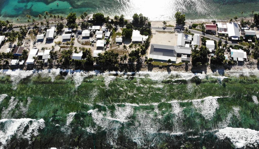 An aerial view of a strip of land between the Pacific Ocean (bottom) and lagoon on November 27, 2019 in Funafuti, Tuvalu. The low-lying South Pacific island nation of about 11,000 people has been classified as "extremely vulnerable" to climate change by the United Nations Development Programme. (Mario Tama/Getty Images)