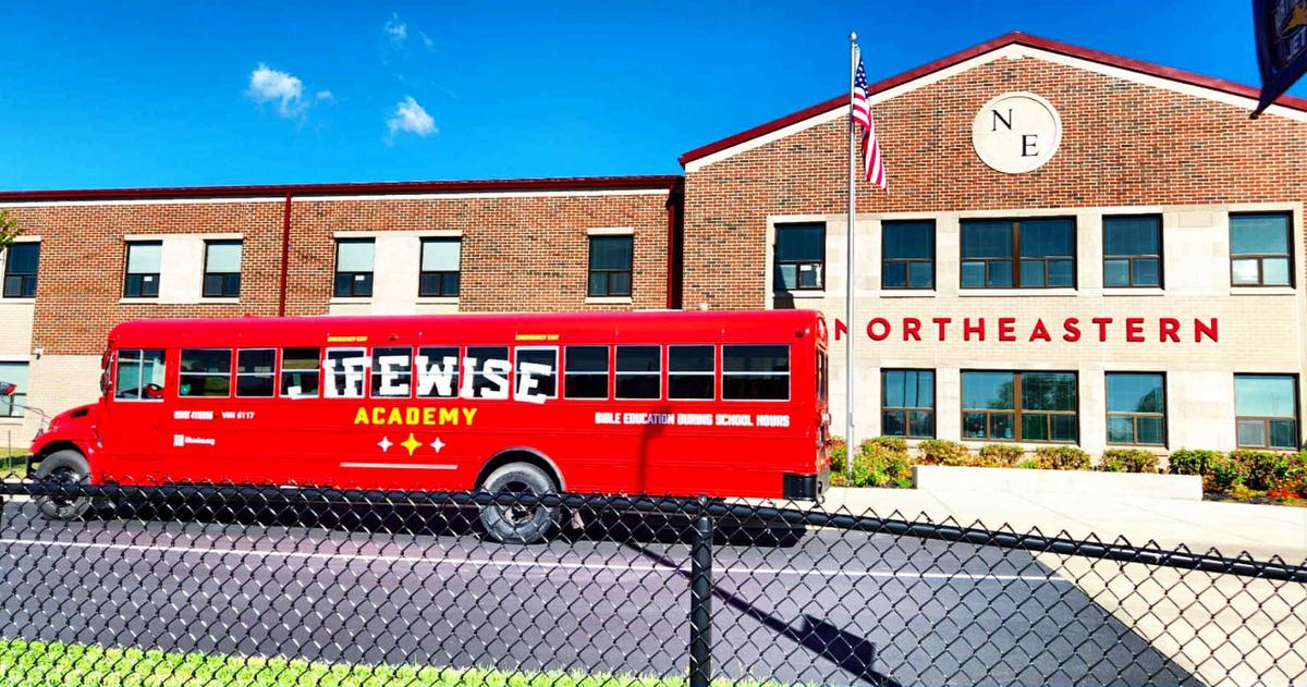 LifeWise’s red bus transports students from the local chapter school to a nearby church. (Courtesy of Nikohl Hamilton)