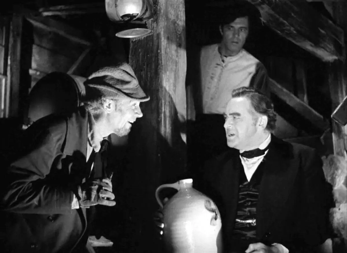 (L–R) Mr. Scratch/the Devil (Walter Huston), Jabez Stone (James Craig), and Daniel Webster (Edward Arnold) meet to negotiate a Faustian deal, in “The Devil and Daniel Webster.” The farmer, Jabez, sells his soul to the devil in exchange for years of prosperity. (RKO Radio Pictures)