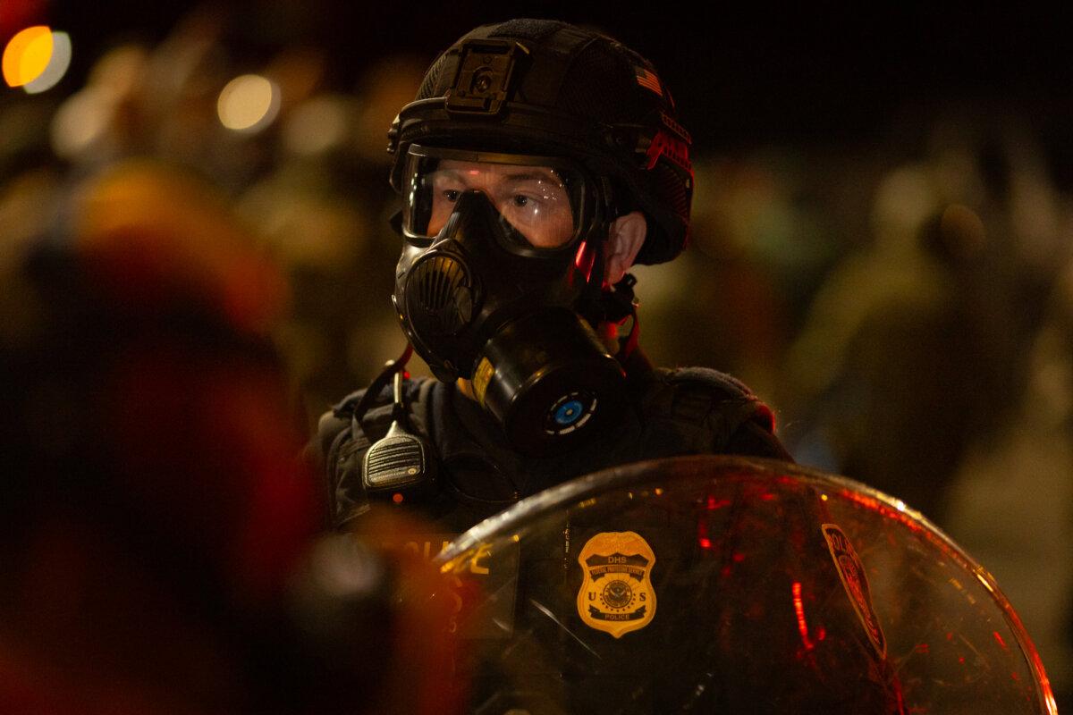 Protestors taunt federal agents in front of Immigration and Customs Enforcement offices in Portland, Ore., on Oct. 3, 2025. (John Fredricks/The Epoch Times)
