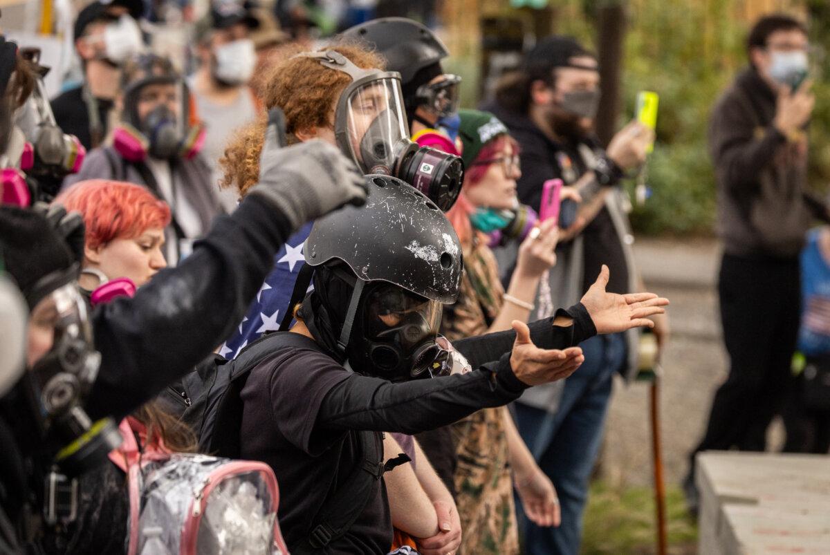 Protesters line up in front of Immigration and Customs Enforcement offices in Portland, Ore., on Oct. 4, 2025. (John Fredricks/The Epoch Times)