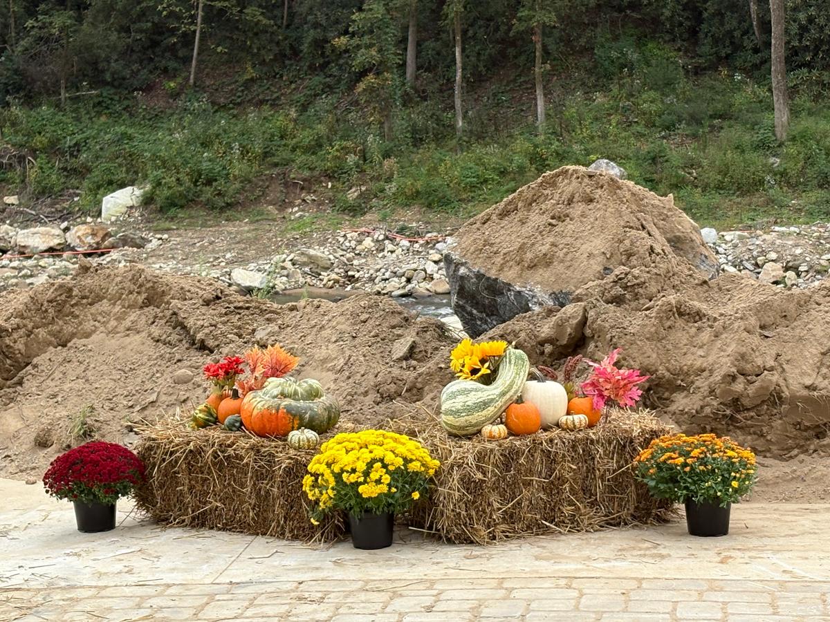 Modest fall-themed decor contrasts with piles of dirt and rubble still present in Chimney Rock, N.C. (Deena Bouknight)