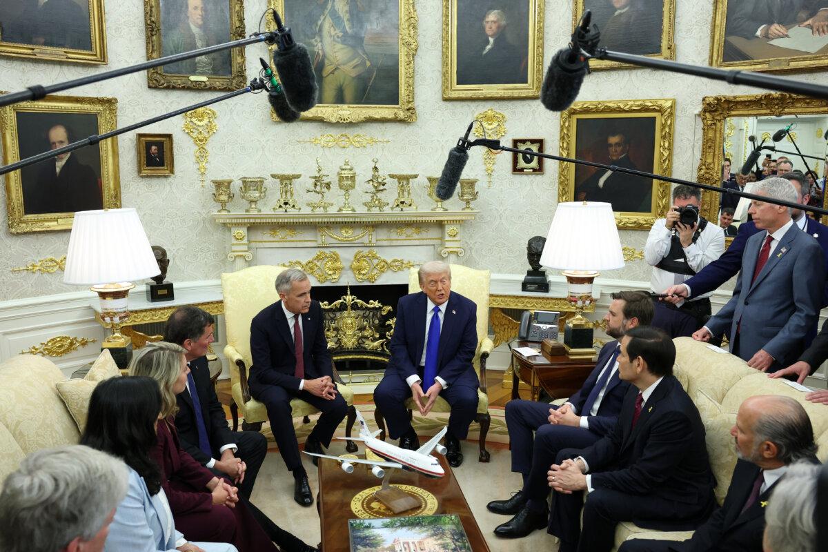 President Donald Trump (C-R) speaks to reporters alongside Canadian Prime Minister Mark Carney (C-L) in the Oval Office of the White House on Oct. 7, 2025. (Anna Moneymaker/Getty Images)