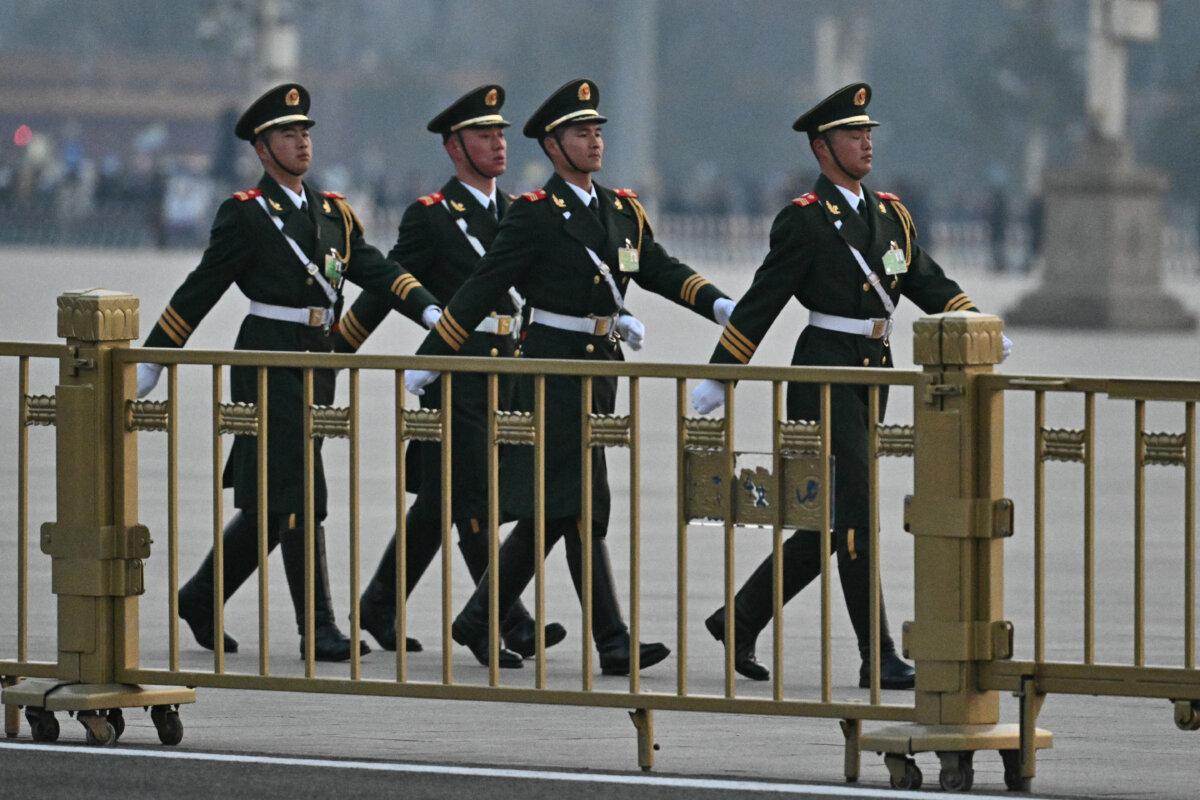 Chinese paramilitary police officers patrol on Tiananmen Square before the opening session of the National People's Congress at the Great Hall of the People in Beijing on March 5, 2025. (Pedro Pardo/AFP via Getty Images)