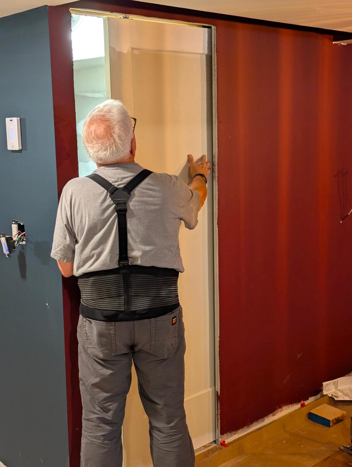 I’m checking a new pocket door in my son’s basement to ensure it glides in and out of the pocket. There are many reasons you should consider several of these doors in your home. (Tim Carter/Tribune Content Agency/TNS)