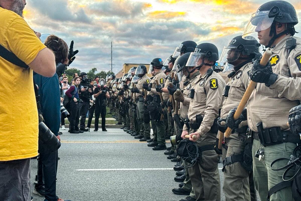 Illinois State Police stand guard as people protest in front of the Broadview ICE Detention Facility in Broadview, Ill., on Oct. 11, 2025. (NTD)