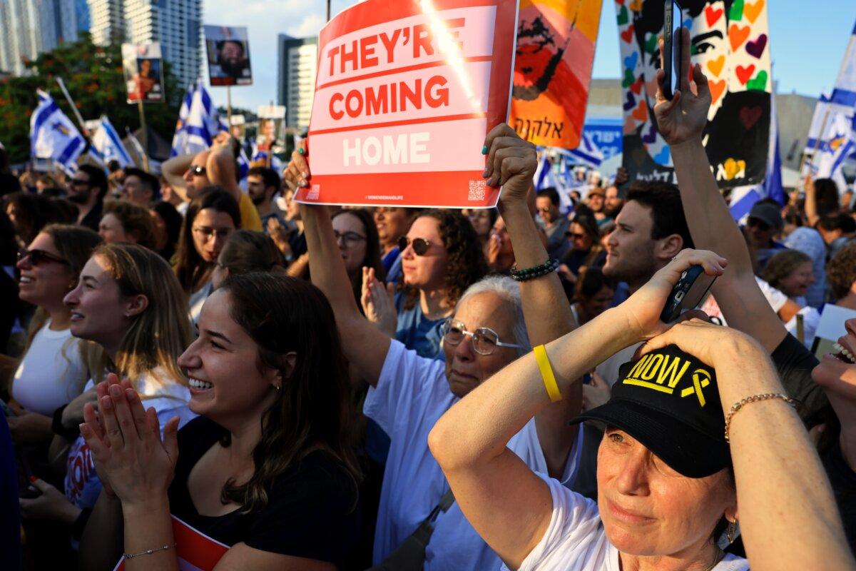 People react as they watch the hostage release live stream at Hostages Square in Tel Aviv, Israel, on Oct. 13, 2025. (Chris McGrath/Getty Images)