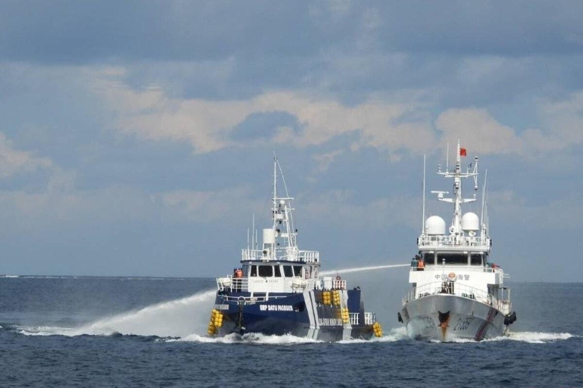 A Chinese Coast Guard vessel (R) fires its water cannon at the Philippines' BRP Datu Pagbuaya near the Philippines' occupied Thitu Island, locally called Pag-asa island, at the South China Sea on Oct. 12, 2025. (Philippine Coast Guard via AP)