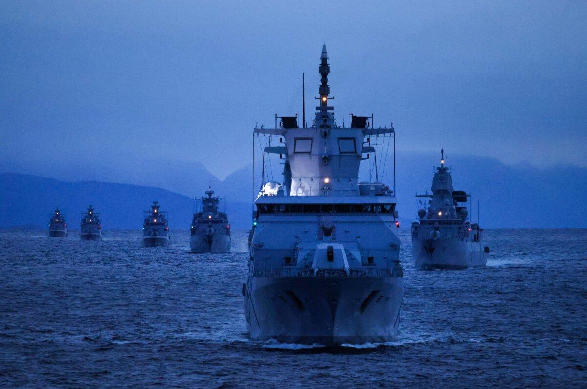 Ships of the German Navy, including the Baden-Wurttemberg frigate (in foreground), sail at twilight during the Andoya "Missile Firing Exercise 2025" military exercise in the North Sea near Harstad, Norway, on Oct. 13, 2025. ( Sean Gallup/Getty Images)