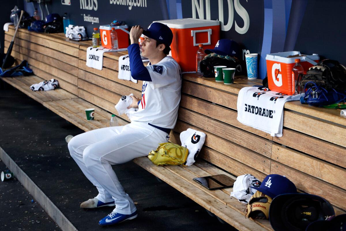 Dodgers pitcher Roki Sasaki #11 looks on from the dugout during the ninth inning against the Philadelphia Phillies in game four of the National League Division Series at Dodger Stadium in Los Angeles, Calif., on Oct. 9, 2025. (Harry How/Getty Images)