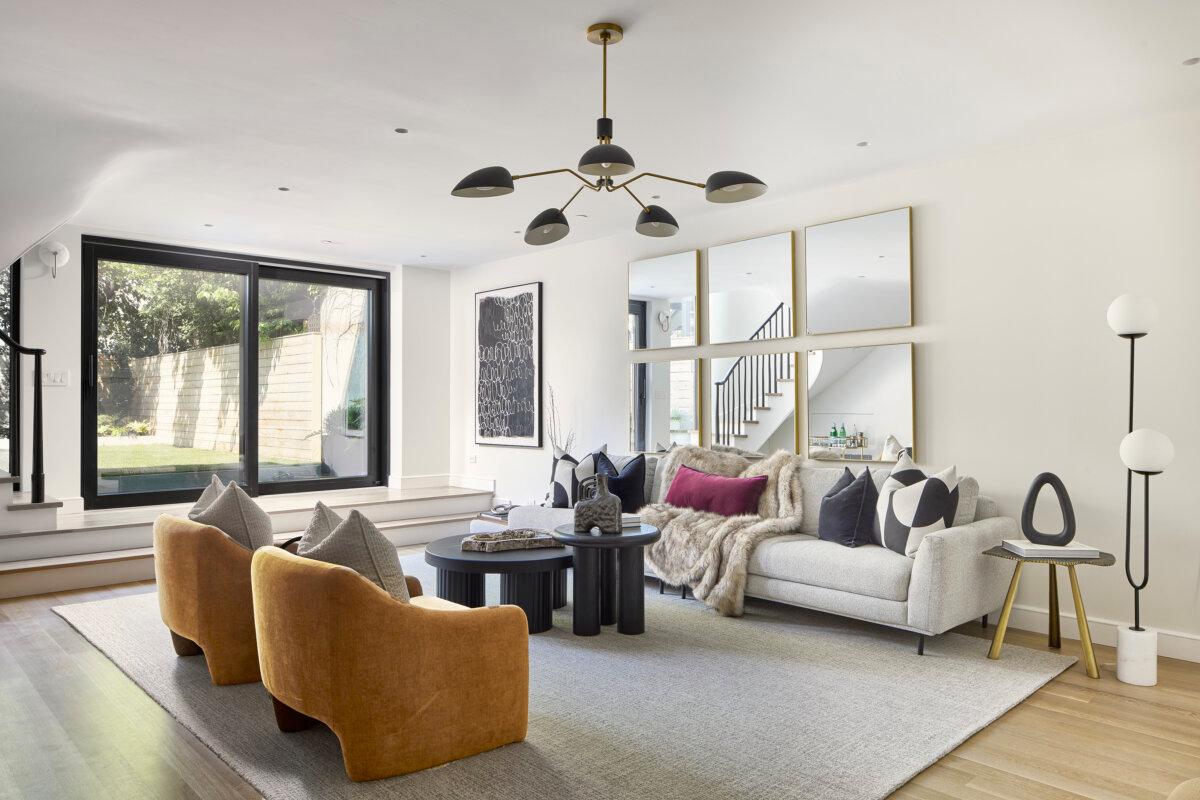A modern living area combines earthy orange chairs with neutral furnishings and layered textures. (Handout/TNS)