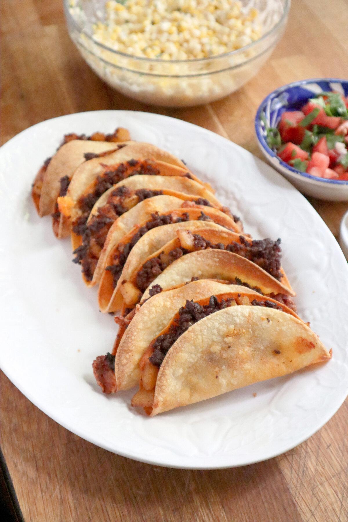 These crispy, cheesy chorizo and potato tacos are baked in the oven to achieve an extra crunch. (Gretchen McKay/The Post-Gazette/TNS)