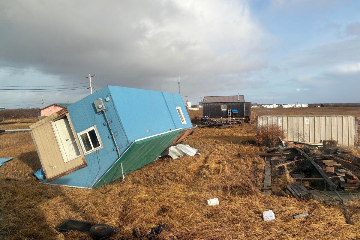 An unoccupied home rests on its roof after being knocked over when the remnants of Typhoon Halong hit western Alaska, in Kotlik, Alaska, on Oct. 12, 2025. (AP Photo/Adaline Pete)