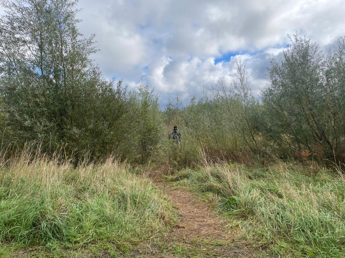 An African immigrant enters a hidden camp in Calais, France, on Oct. 15, 2025. (Owen Evans/The Epoch Times)